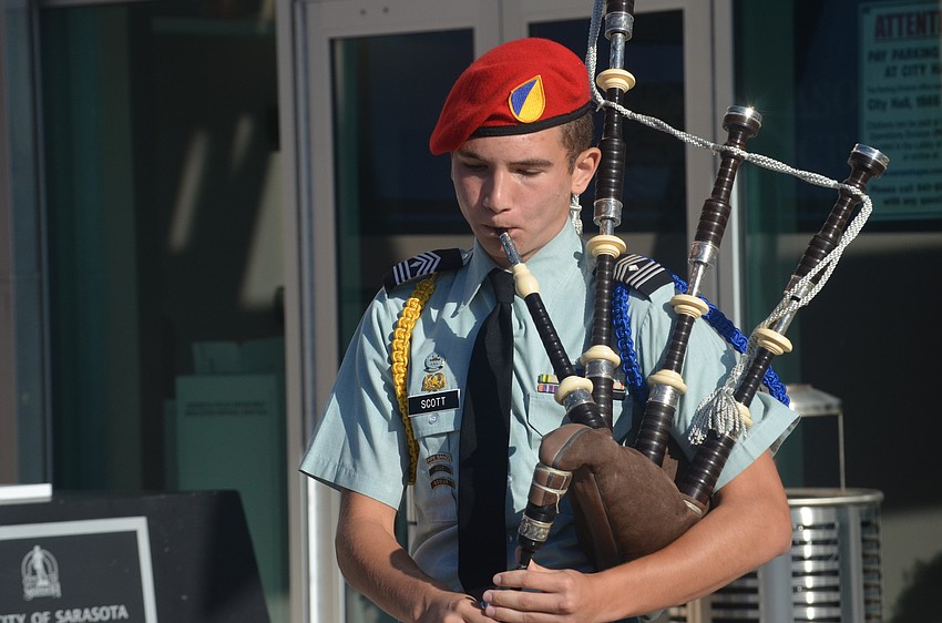 Sarasota Military Academy sophomore Houston Scott plays the bagpipes during the ceremony.