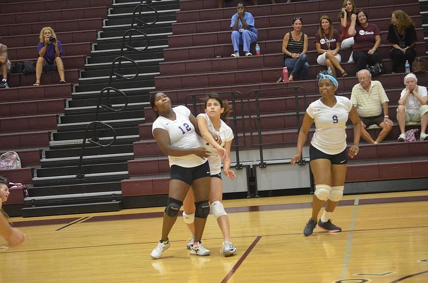 Booker players Kellisha Bellamy, Yamaris Guevarez and Kameron Kirce watch the volleyball as they try to get to it in time.