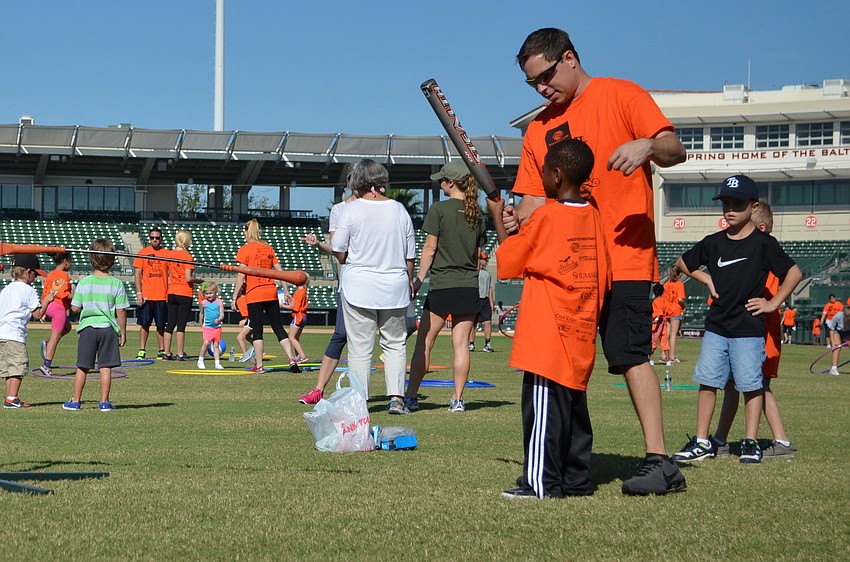 Wayne Ard coaches Xavier Henderson on how to properly hit a baseball.