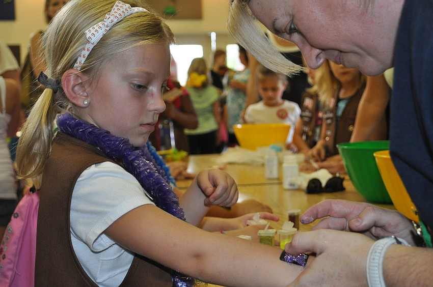 Rylee Boyce gets a glitter tattoo on her arm.