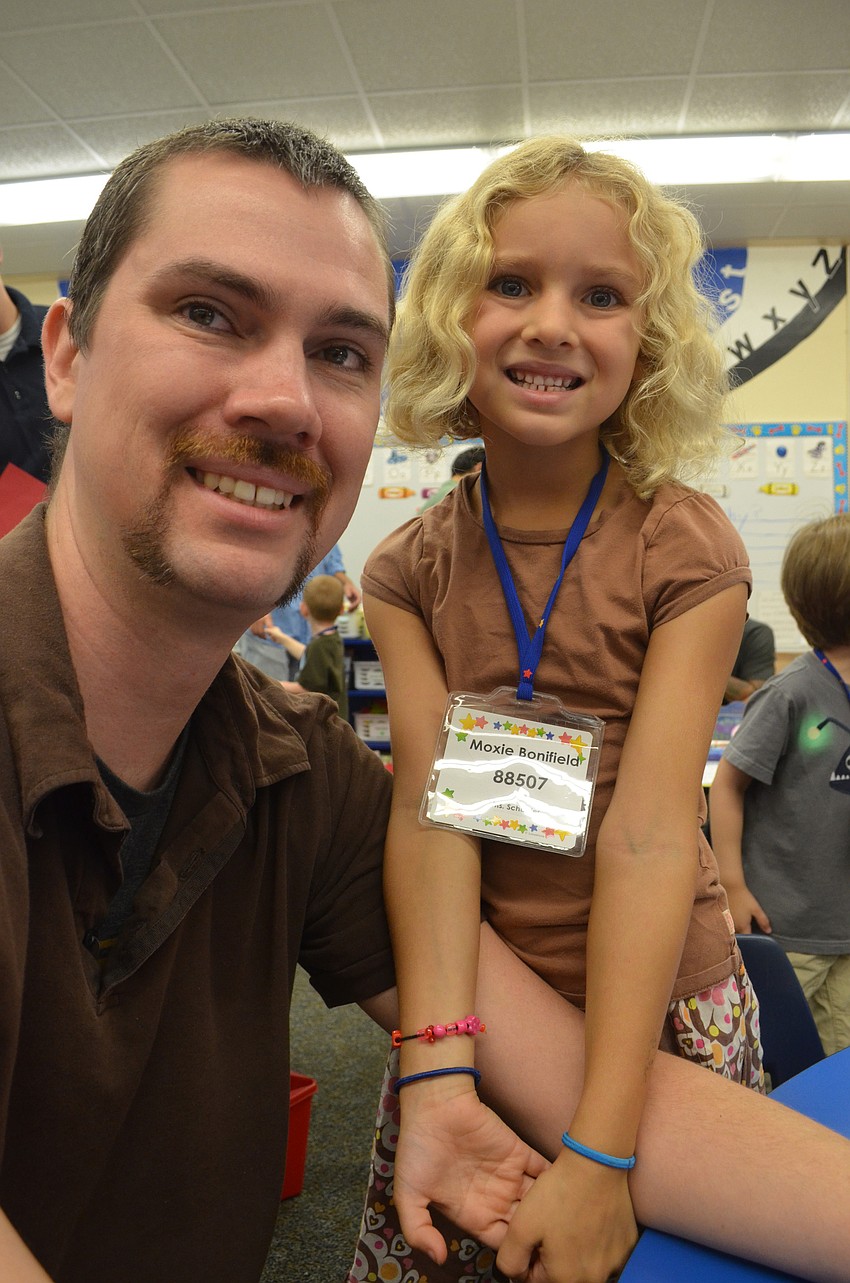 Kent Bonifeld hangs out with his daughter, Moxie, before school announcements.