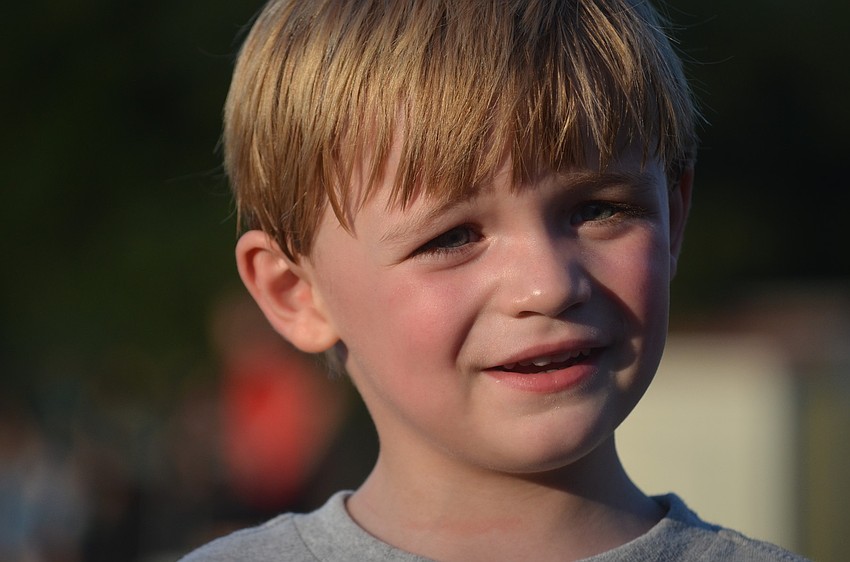 Grant Yeagley, 3, plays with other children during the tailgate.