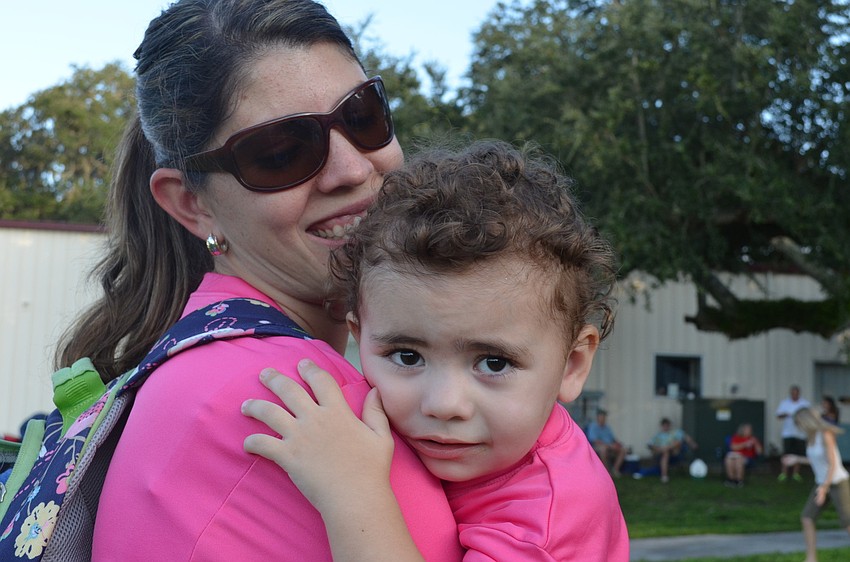 Vicki Skidmore and her daughter Sofia, 2, play at the tailgate.