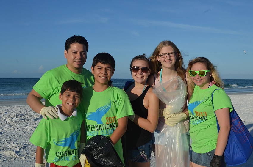 Hector Gutierrez his sons Anthony, 10, and Justin, 12, and Brookside Middle School students Jessica Reck, 13, Emma Bailey, 13, and Micaela King, 13, help keep their community clean.