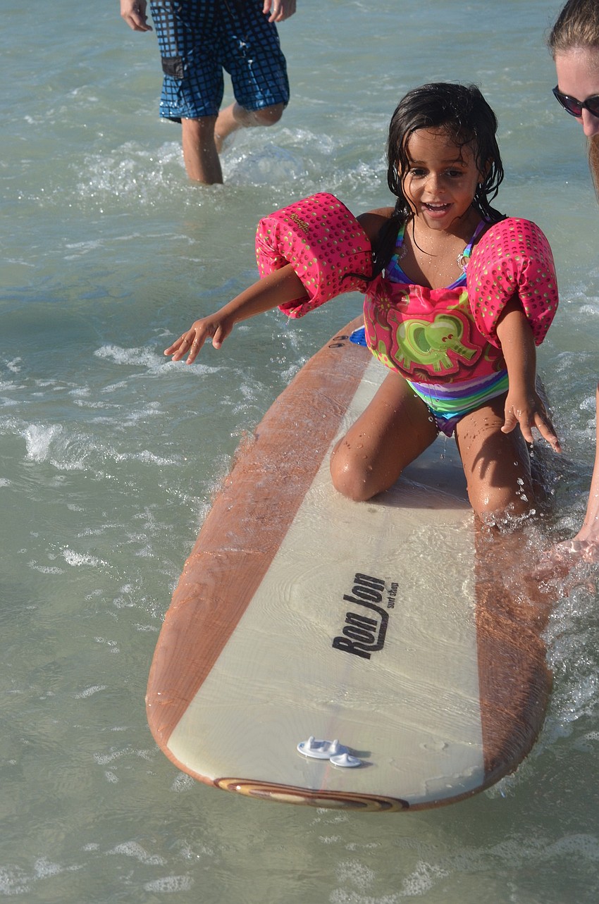 Thomais Moshopoulos, 5, was hesitant to get on the surfboard at first but soon learned to love it.