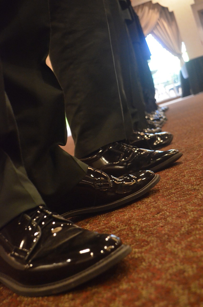 Sarasota Military Academy students shine their shoes to keep up with the uniform policy.