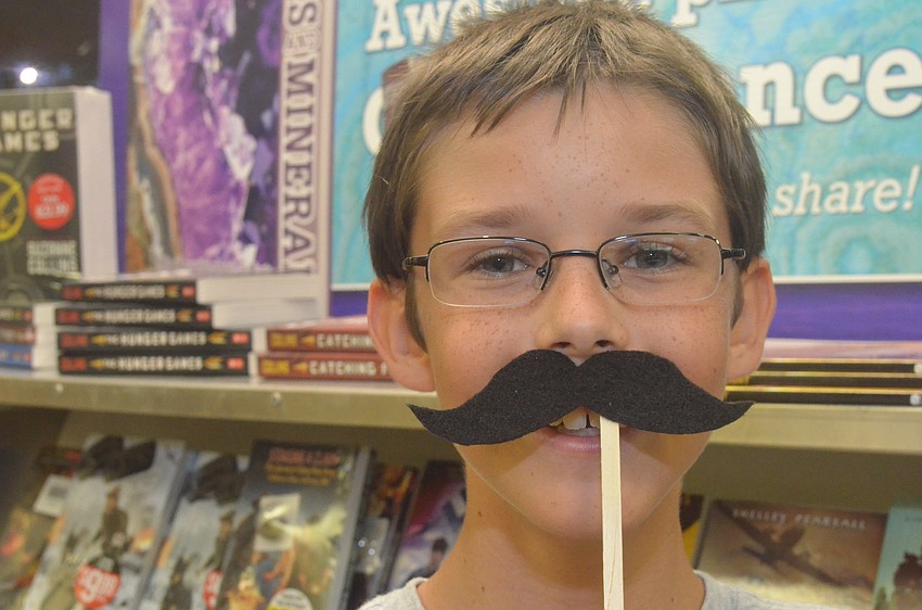 Jaedon Jensen, 12, made a felt mustache at the book fair.