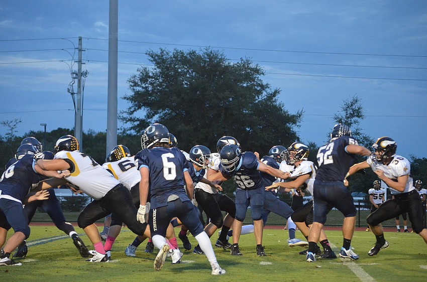 Lineman Quinton Fitzgerald and is teammates push through the opposing team.