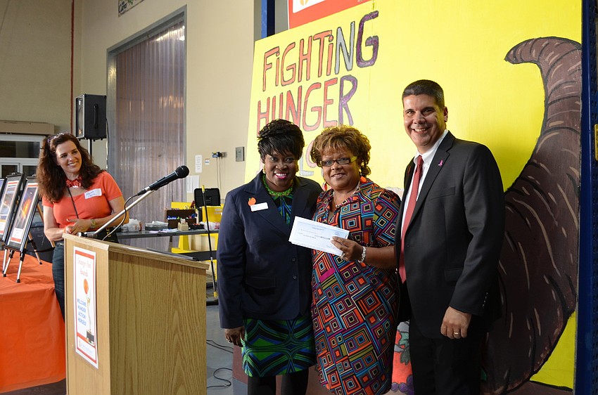 Carolyn Robinson, Aundrina Castleberry and Jim Santarsiero with the $12,000 check Bank of America presented All Faiths Food Bank with Friday, Oct. 11, at the Orange Peel Awards.