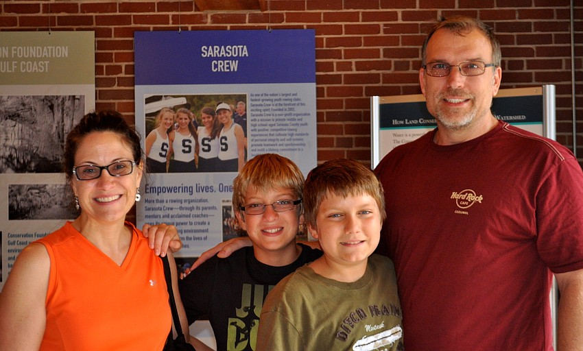 Candy, Tyler, 12, Will, 11, and David Mizer prepare to walk through the festival.
