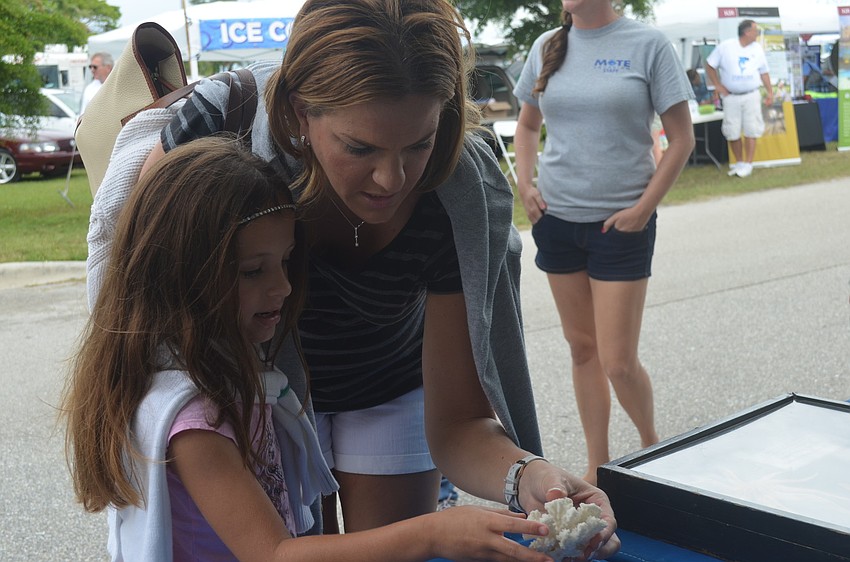 Gabby and Tammy Valenzuela learn about marine animals at the Mote Marine booth