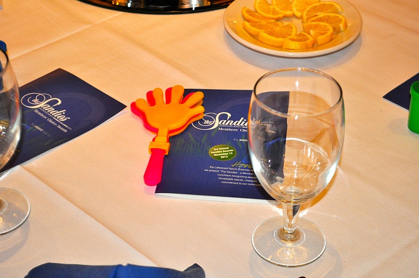 Whistles, plastic hands that clap together and other noisemakers line tables in the ballroom.
