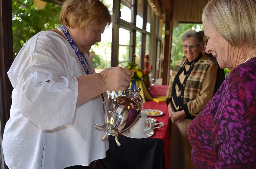Kathy Ellis pours Gunilla Dorsen a cup of tea