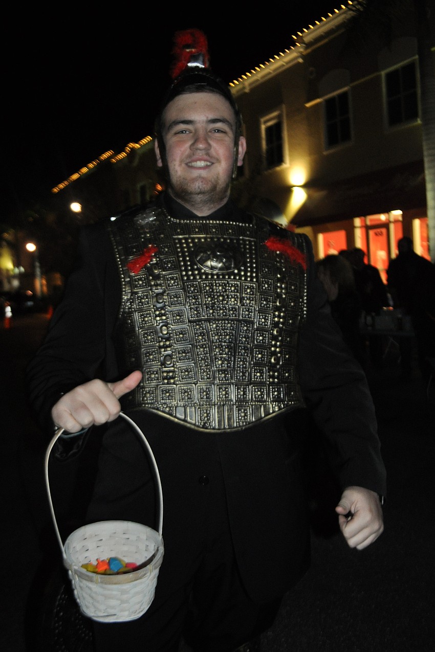 Landon Heitner, as Judah Maccabee, hands out dreidels.