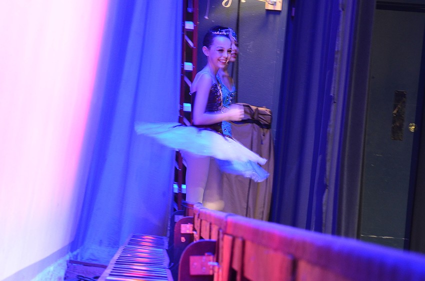 Ashlynn Rutherford and Rachel Silverman have fun on the wings awaiting their turns to perform.