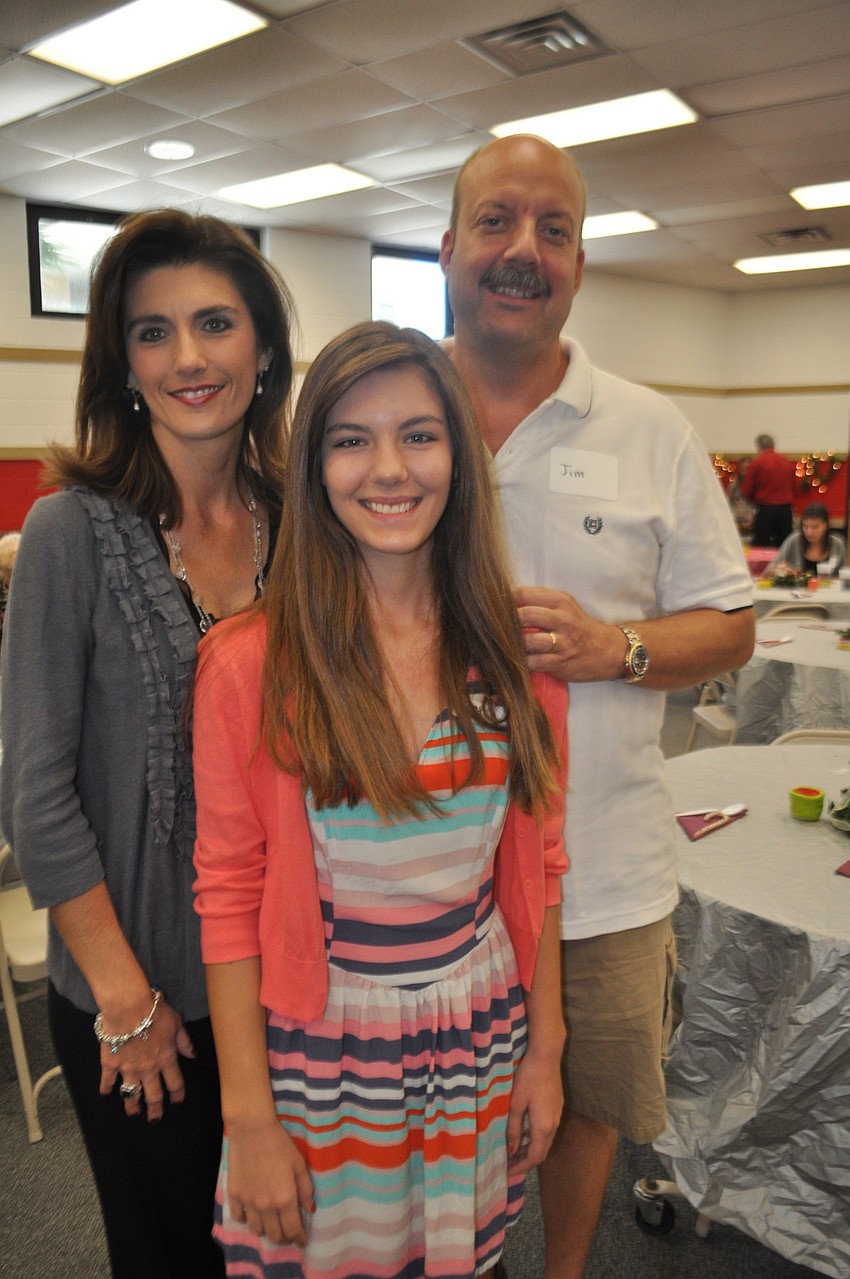 Nikke and Jim Shilling greet their daughter, Abbey, center, vice president of Braden Riverâ€™s Junior National Honor Society.