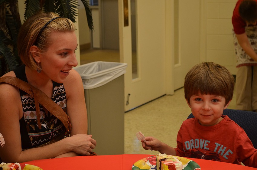 Ali Weston with Beckham MacIntyre enjoy cake