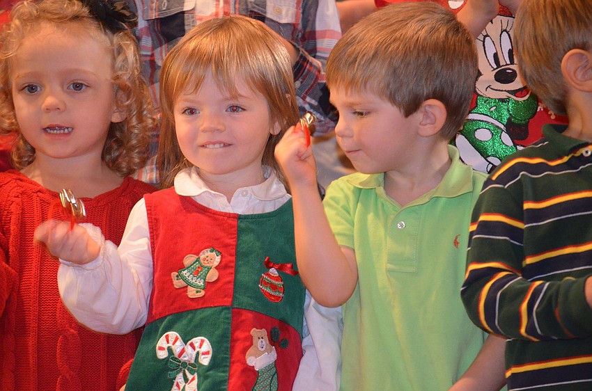 Molly Harris, Parker Barsell and Charlie Horn play â€œJingle Bellsâ€.