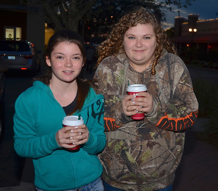 The Lepley sisters â€” Sabrina, 14, and Skylynn, 16 â€”warm their hands with warm Starbucks drinks.