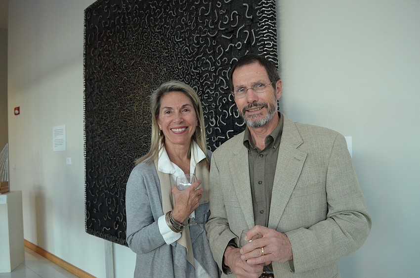 Barbara May and Steve Kreidler in front of a piece by Jae-Hyo Lee