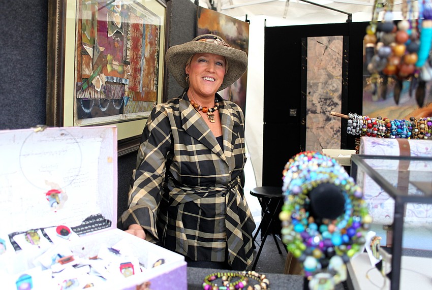 Suzanne Bellows displays her work at her booth for Blue Palms Fiber Art.
