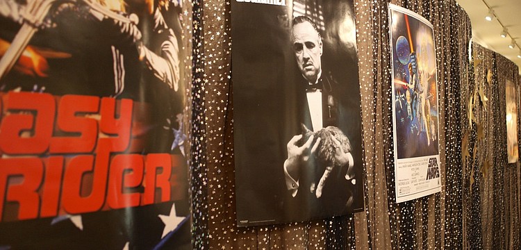 Posters of films favorites like â€œThe Godfatherâ€ and â€œEasy Riderâ€ adorn the walls.