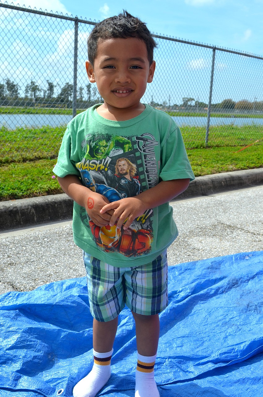 Edimar Lopez, 3, prepares to take his turn on the slide.
