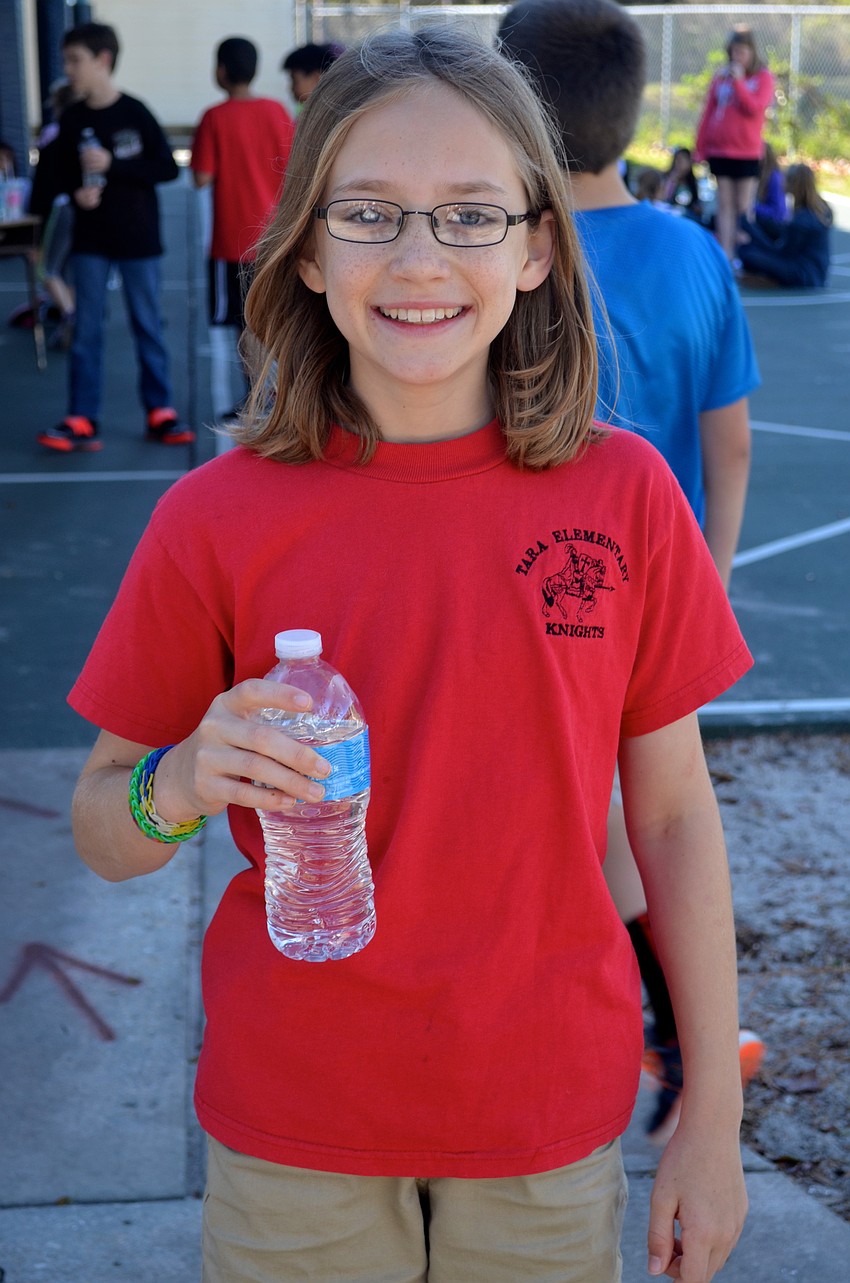 Jacquelyn Bouchard, 11, gets hydrated after her work out.