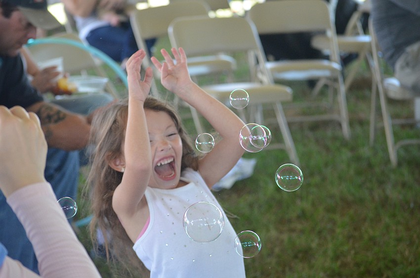 Nicole Gilman tries to catch bubbles.