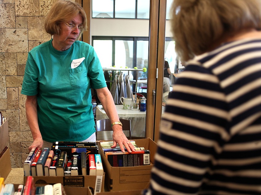 Eleanor Cloud neatly organizes books by genre.