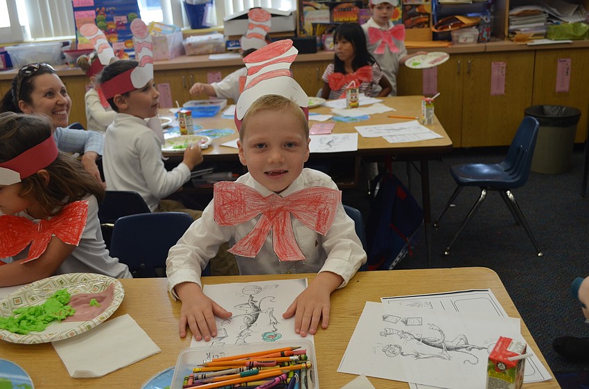 Erik Hermansen colors a picture of the Cat in the Hat.