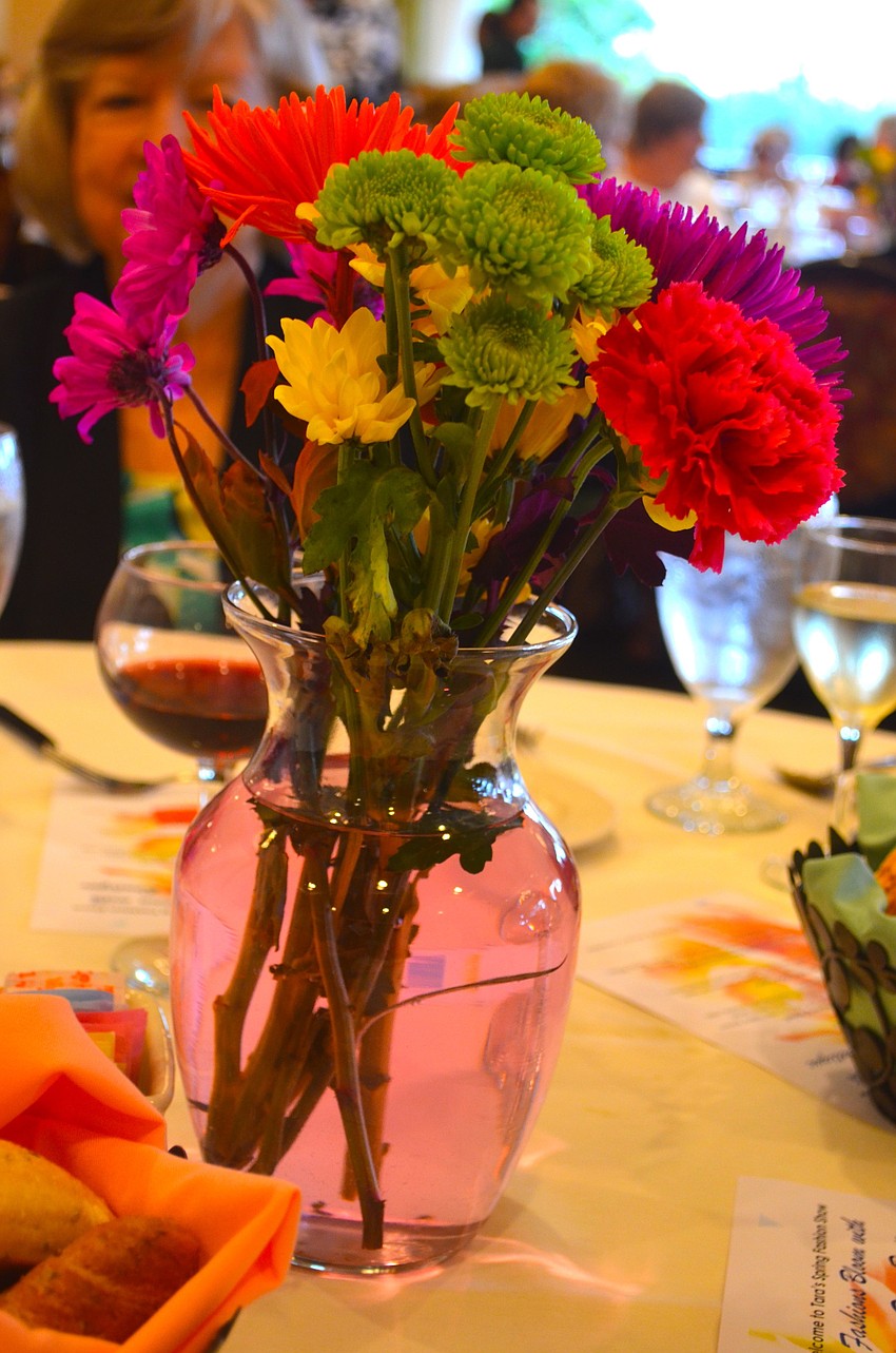 Bright, multi-colored flowers in vases decorated each table at the event.