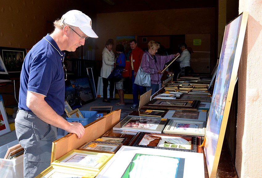 Ron Elms browses through the art.