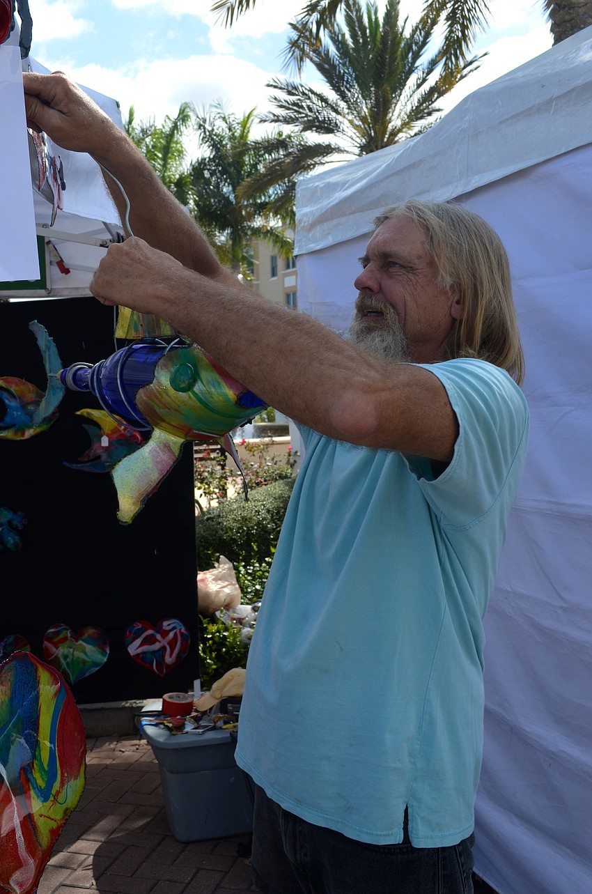 Artist Kevin Webb prepares his booth for his next visitors.
