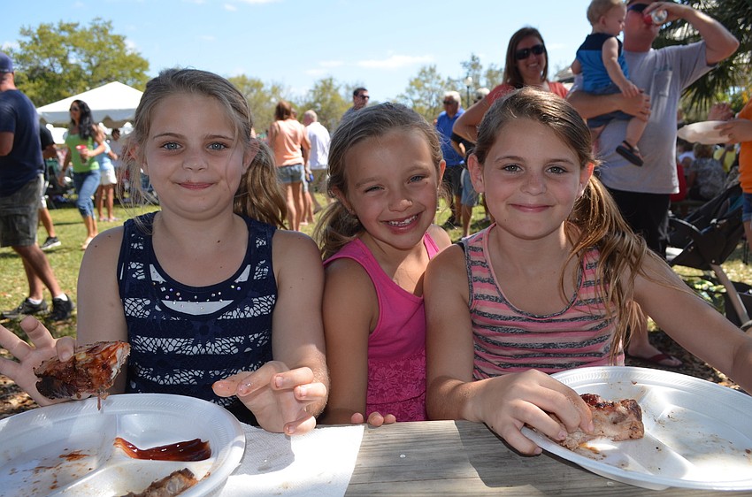 Lacey Currier, Ryelee Lococo and Alyssa Currier finish their plate of ribs.