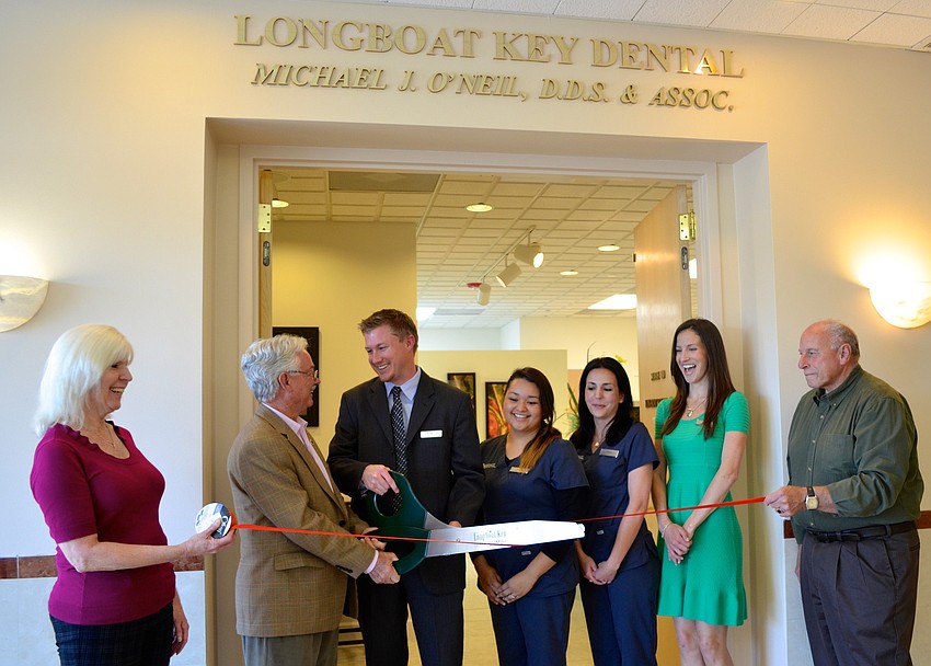Mayor Jim Brown, Dr. Michael Oâ€™Neil and his staff laugh as the scissors fail to cut the ribbon.