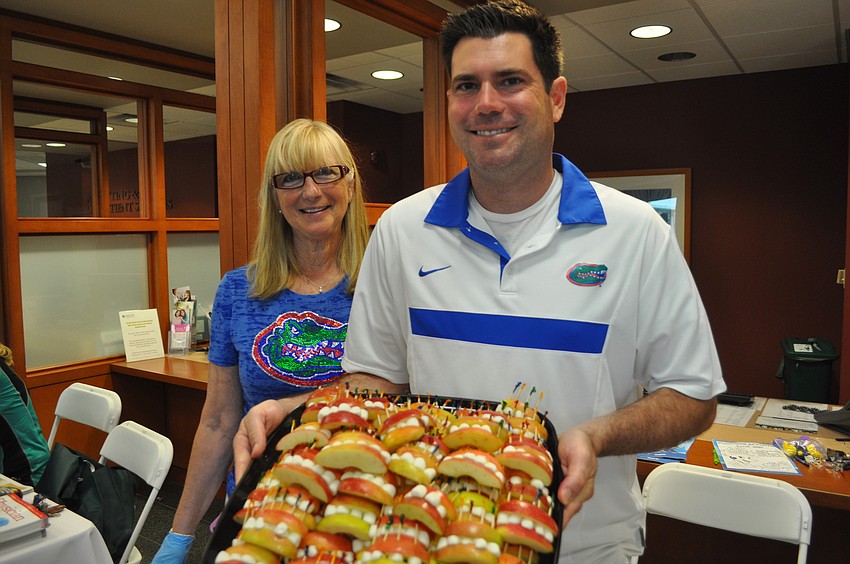 Karon Ashley and her son, David, a dentist at Smile Smart Dental Center, show off a unique treat.