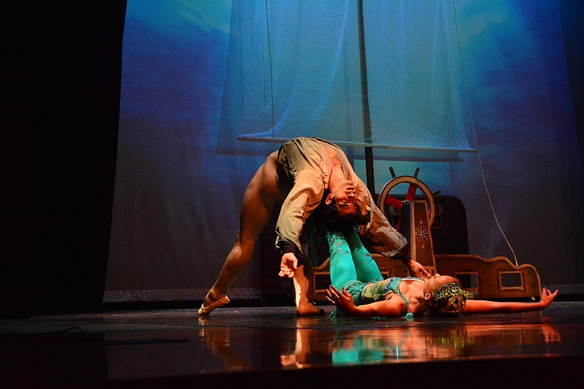 The prince, played by David Martinez Coro, swirls through the ocean during a storm with the mermaid, Lauren Henry.