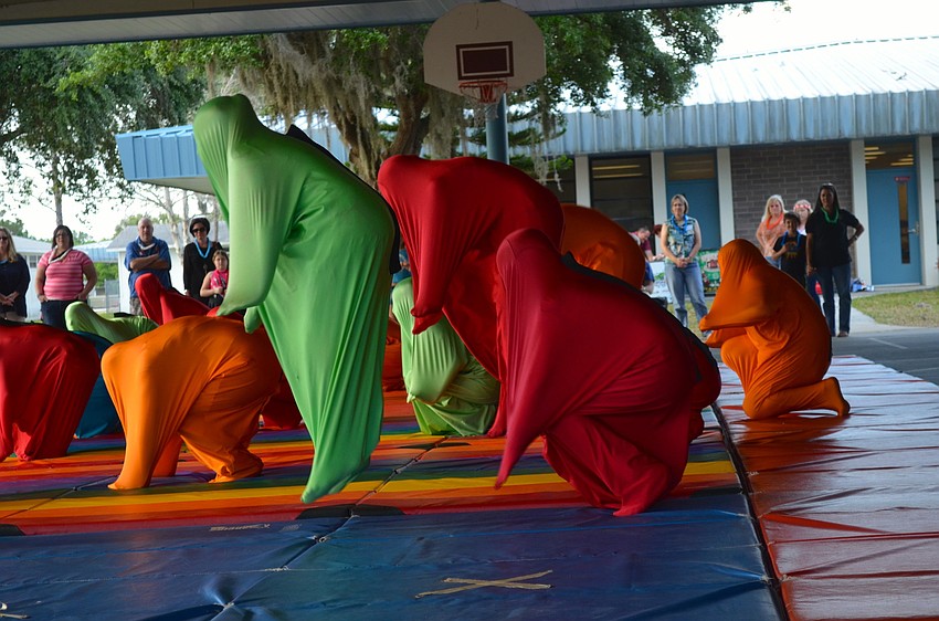 Tara Elementary's dance team performs to ghoulish-themed songs, while wearing ghost costumes.