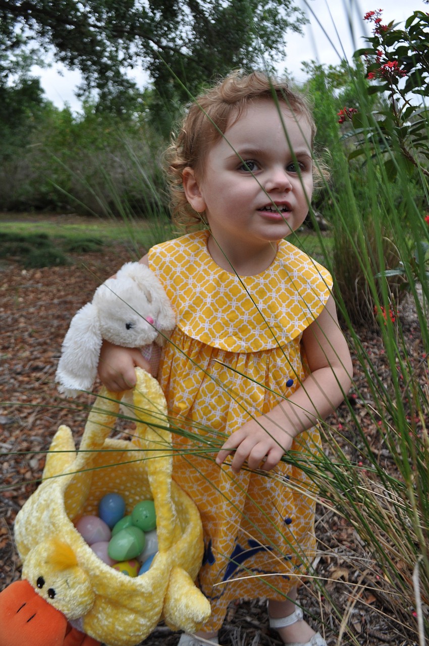 Two-year-old Everly Gannuch finds an egg in a patch of sawgrass.