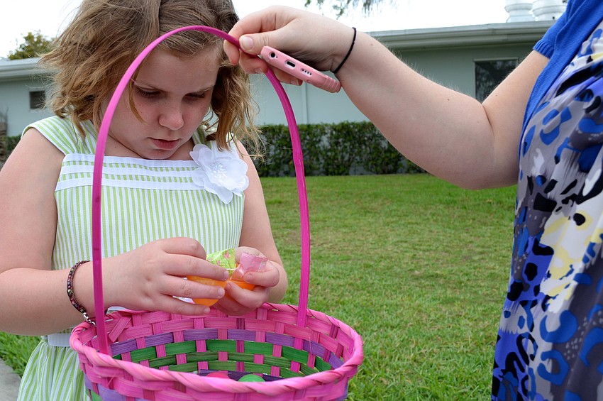 Charley Fowler opens an Easter egg to see her prize.