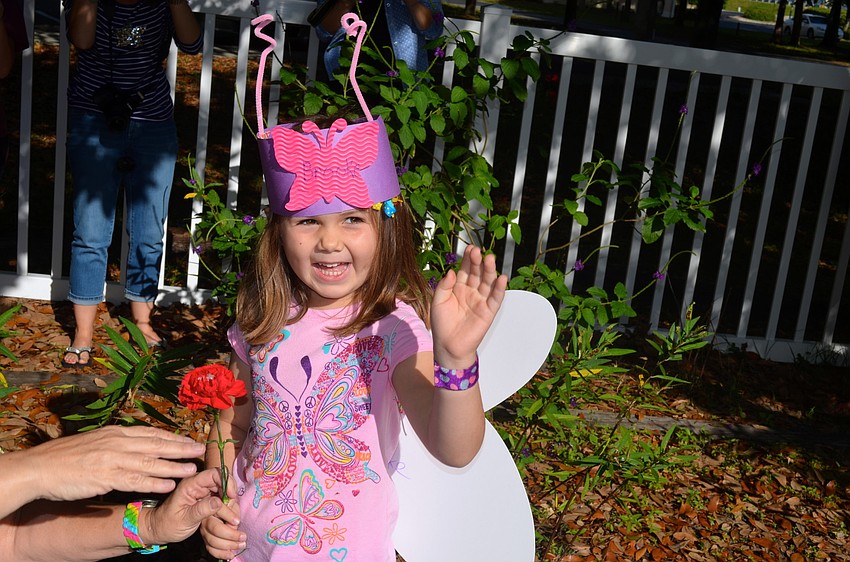 Brooke Meyers waves goodbye to her butterfly.