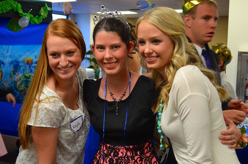 Leah Barger, flanked by volunteers Kayla McNulty and Savannah Cummings, can't stop smiling.