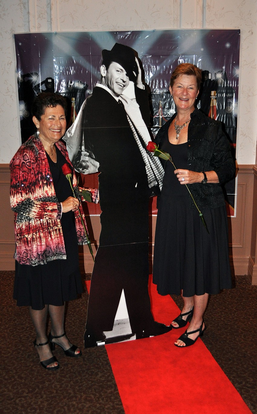 Carolyn Nathan and Ann Ruffing pose with a cut out of Frank Sinatra on the red carpet.