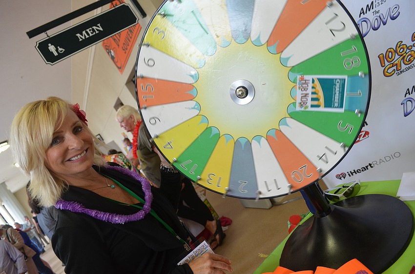 Lulu S. spins the wheel at the Clear Channel Media and Entertainment booth.