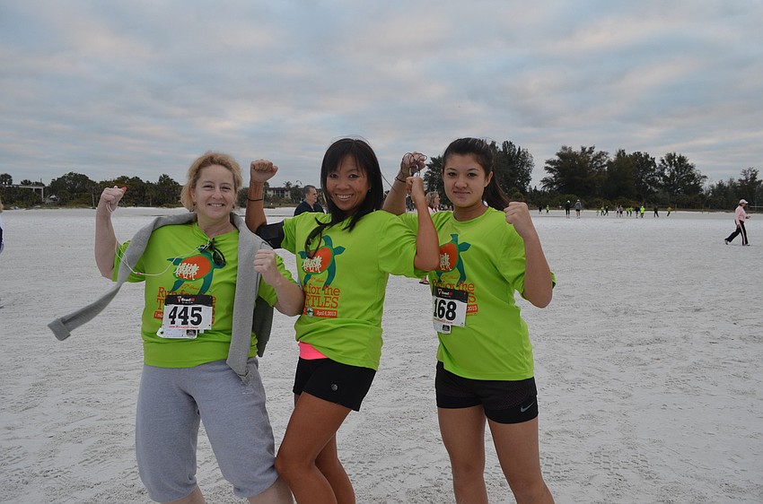 Jackie Donahue gets ready to run with her daughter Haley (right) and friend Kim Parrado (left).