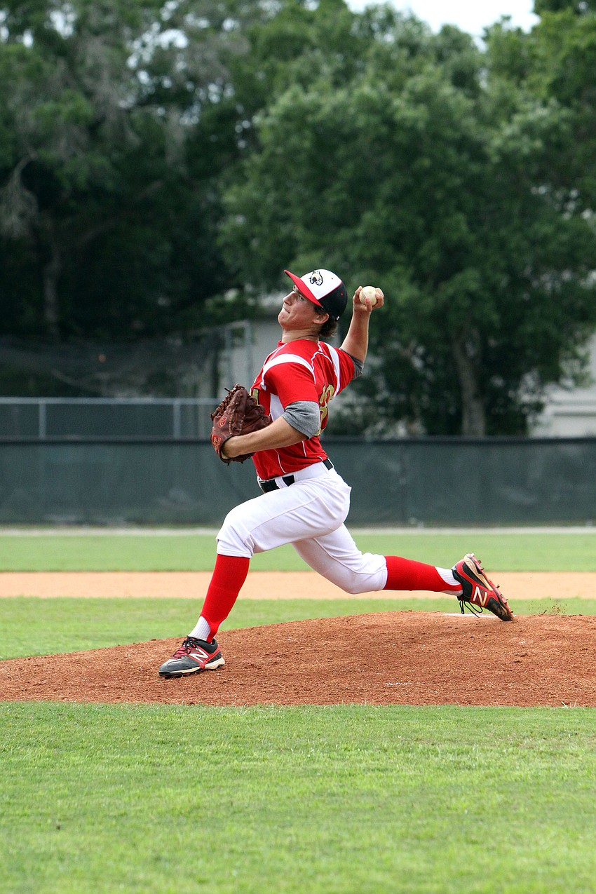 Cardinal Mooneyâ€™s Garrett Schrantz, No. 32, throws the ball at home plate.