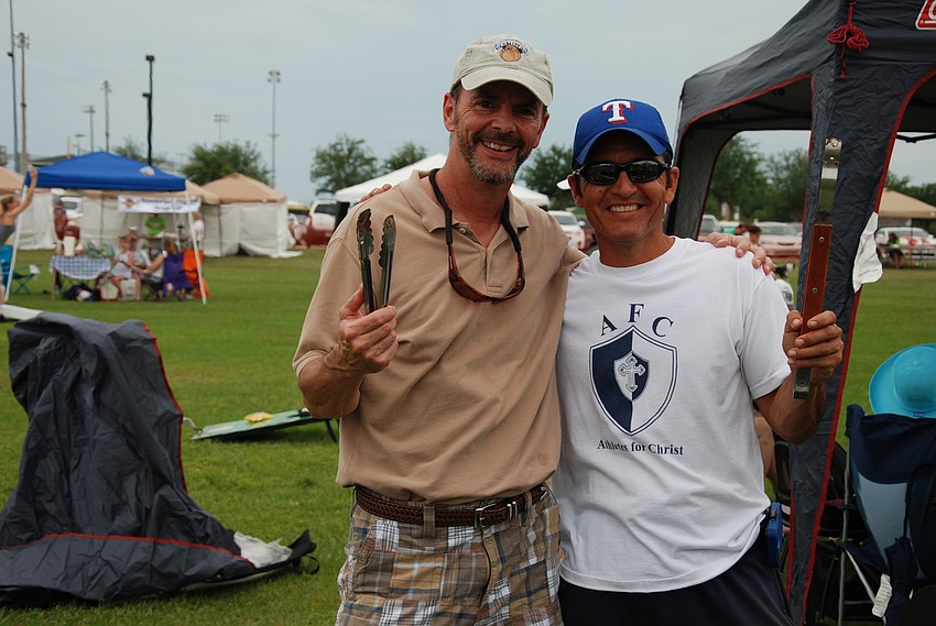 Dan Draper and Jose Macias catch up while they grill burgers during the cook-off.