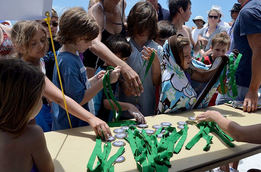 Winners reach for their medals.