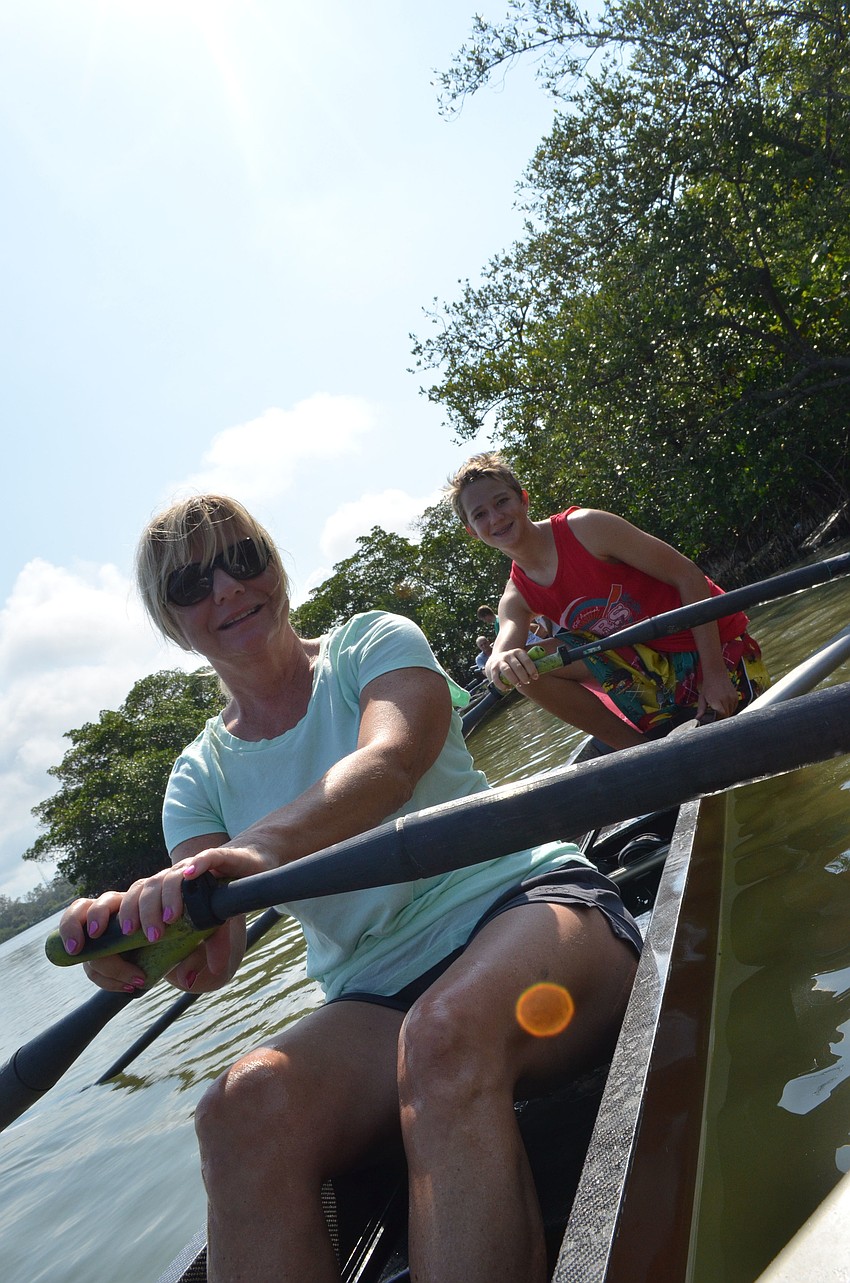 Sam Somogyi teaches his mom Melody how to row.